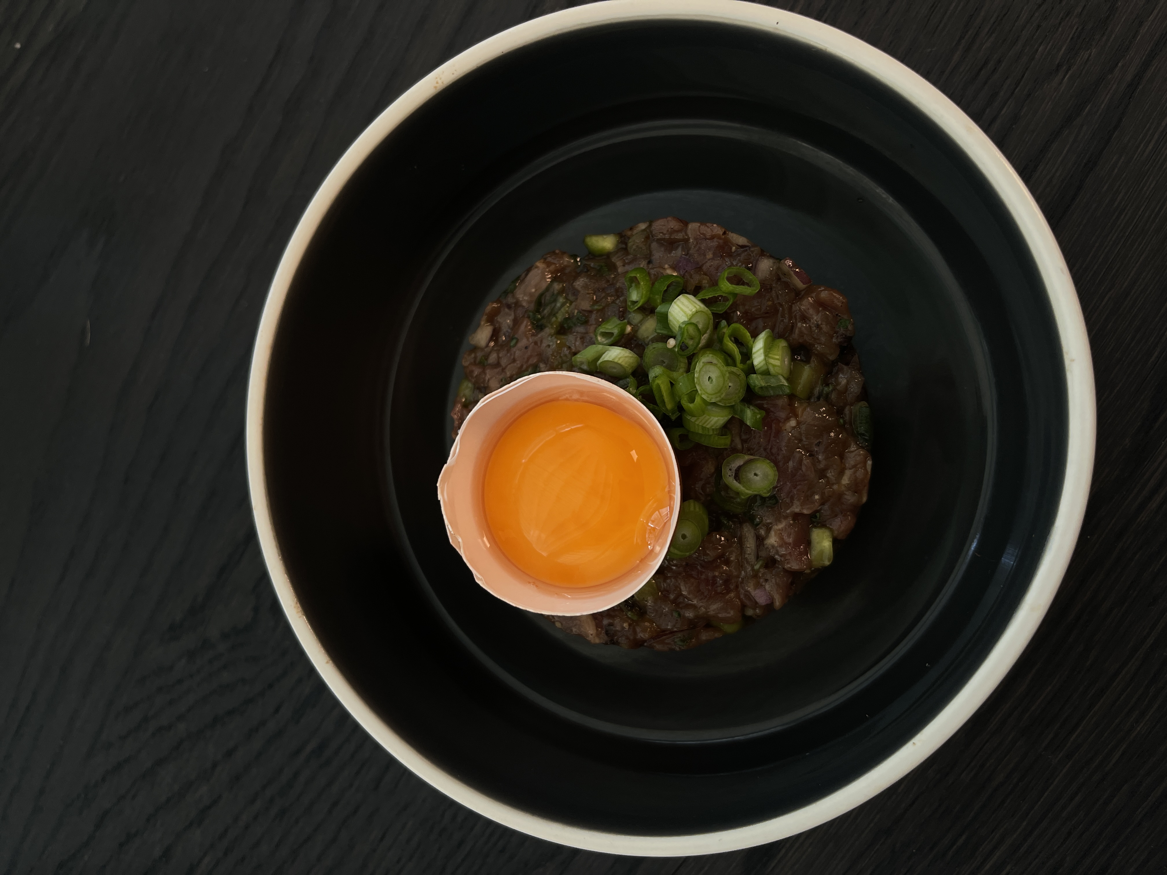 Schüssel mit Essen und einem Eigelb obendrauf