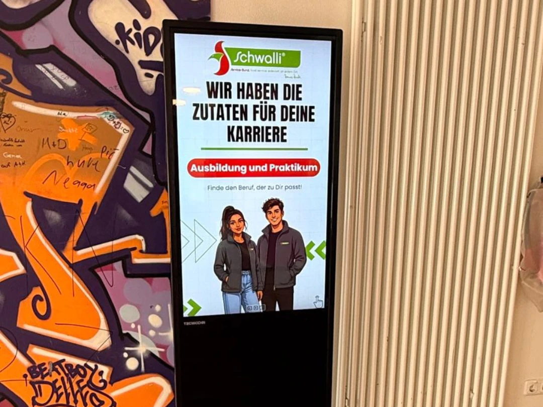 Bildschirm auf einem Ständer mit Text und grafischem Design.